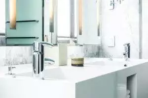 white porcelain sink with towels