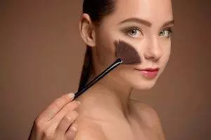 beauty girl with makeup brush perfect skin applying makeup