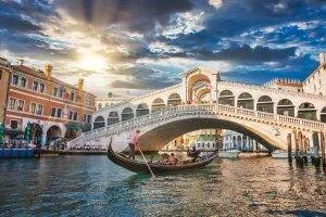 traditional gondola near world famous canal grande rialto bridge