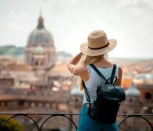 young attractive smiling girl tourist hat exploring new europe city summer holiday