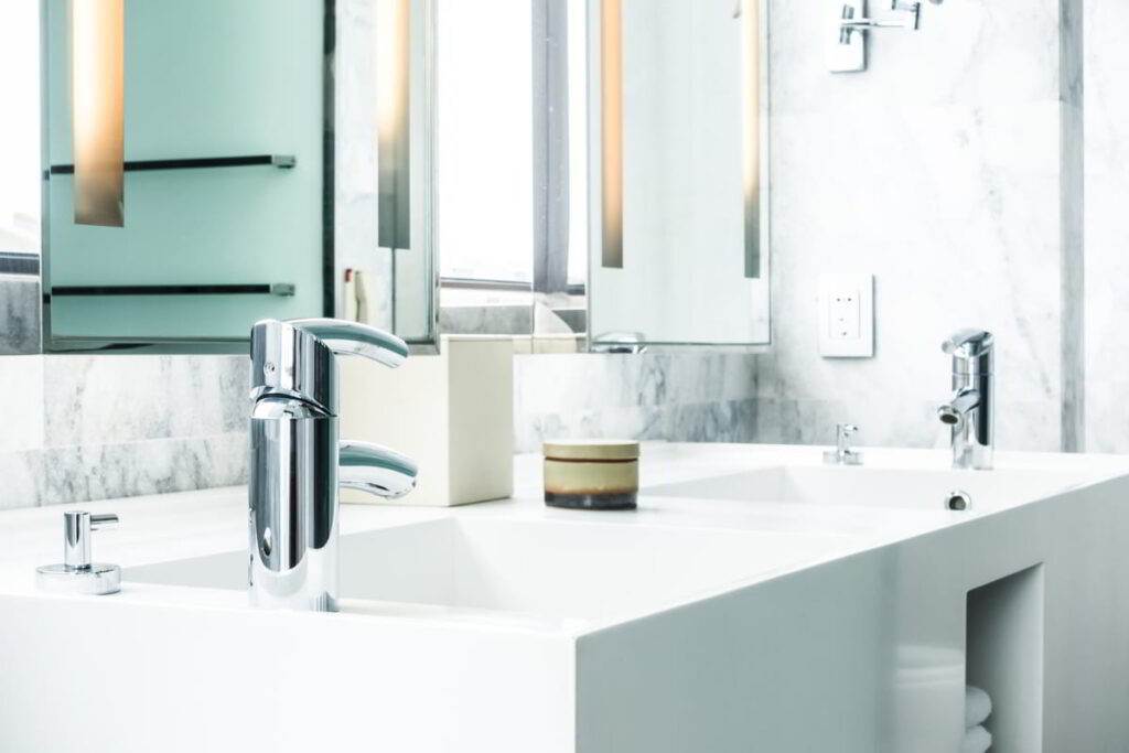 white porcelain sink with towels